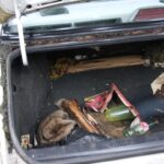 Filthy car trunk before cleaning and restoration.