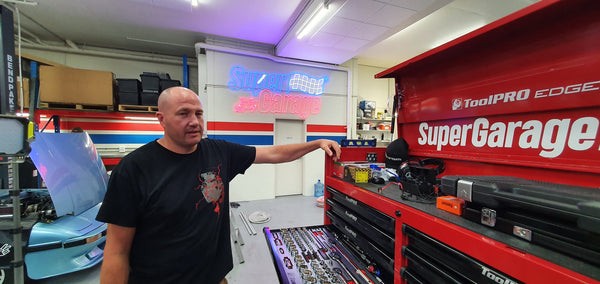 Mechanic Paulie showcasing his organized toolbox drawers