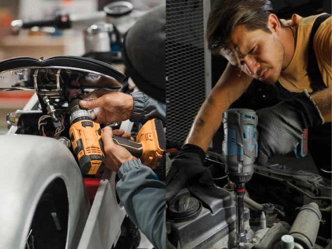 Two mechanics using cordless impact wrenches to repair a car engine in a professional auto shop