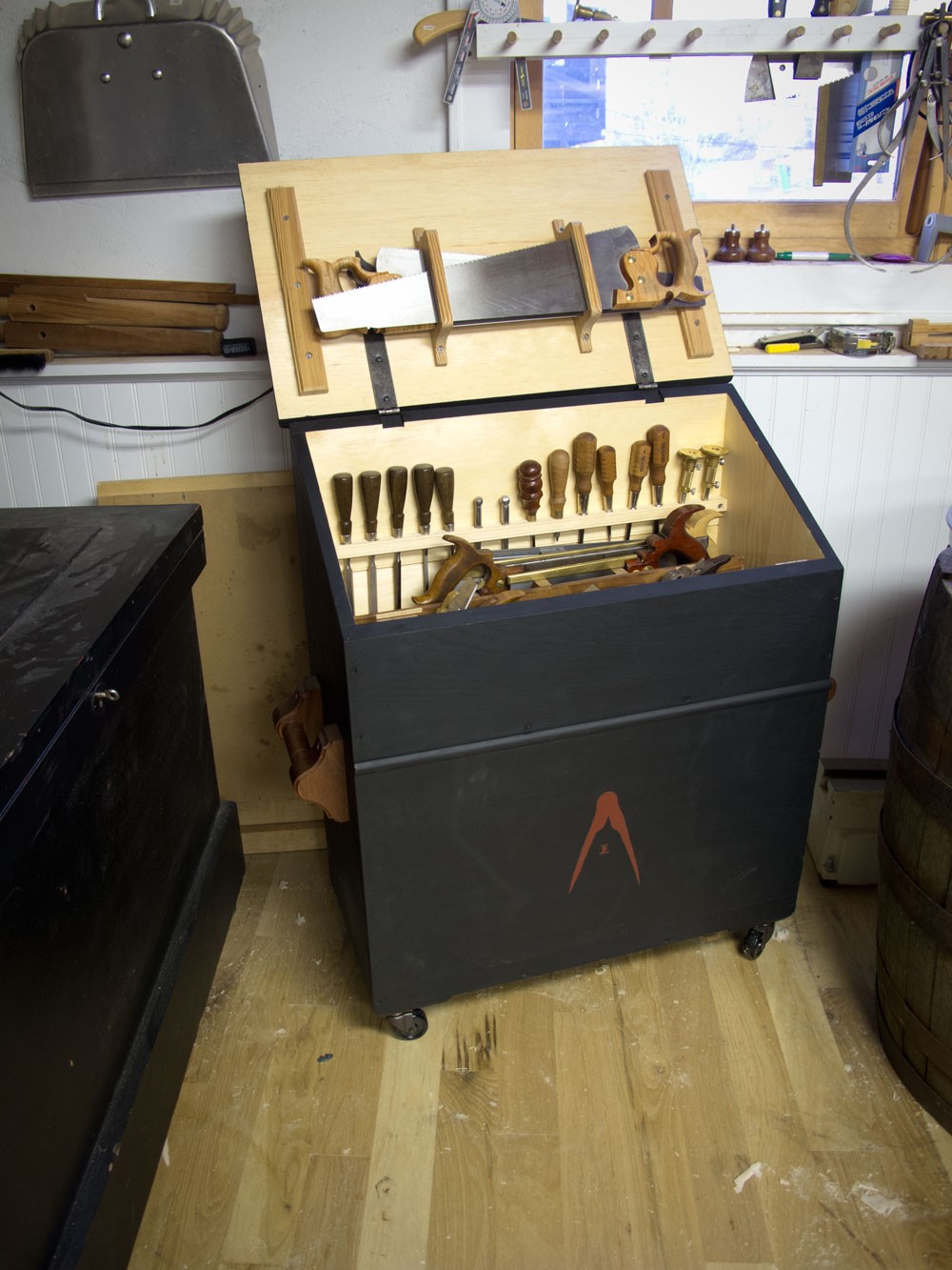 A sturdy wooden tool chest with organized compartments, ideal for inspiration for a robust car trunk tool storage solution.