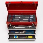 A well-stocked toolbox, but you only need a few essential tools like wrenches and pliers to change your car battery.