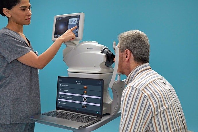 Luminetics Core system being used to examine a patient's eyes, highlighting its role in point-of-care diagnosis for diabetic retinopathy.