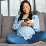 Pregnant woman uses mobile device