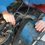 Using a stethoscope to pinpoint a noisy water pump bearing.