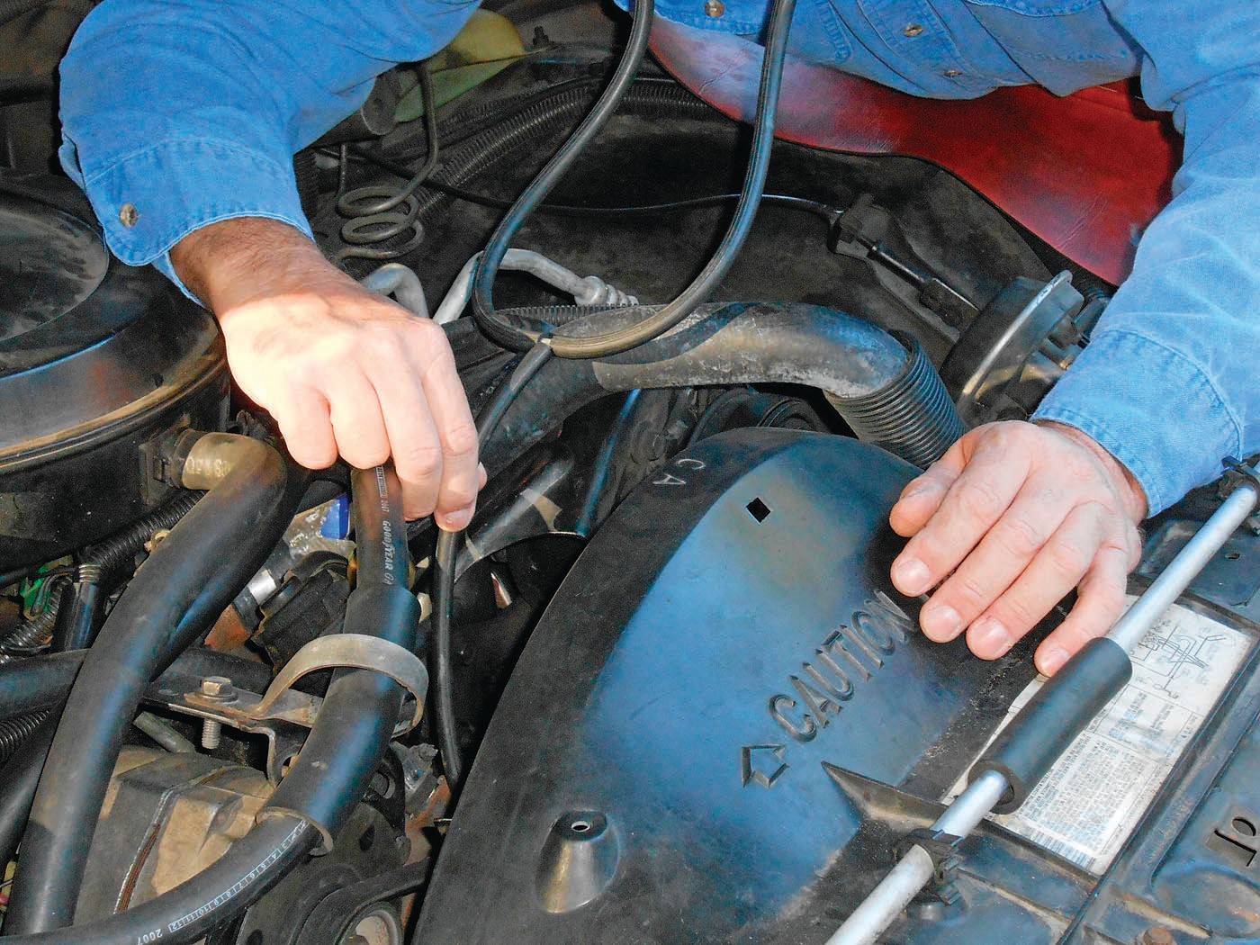 Using a stethoscope to pinpoint a noisy water pump bearing.