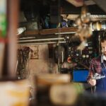 Home car mechanic inspecting engine with wrench