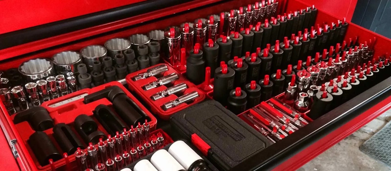 alt text: A collection of essential hand tools for basic auto repair including wrenches, sockets, ratchets, pliers and screwdrivers.