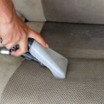 Vacuuming pet hair from a car seat