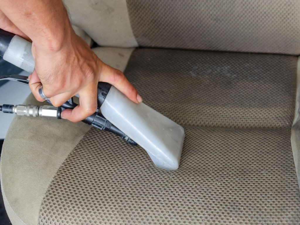 Vacuuming pet hair from a car seat